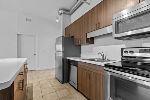 a kitchen with stainless steel appliances and wooden cabinets