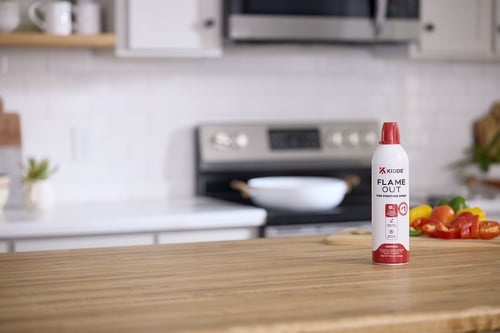 Kidde KAP-14K fire spray on a wooden countertop in a kitchen