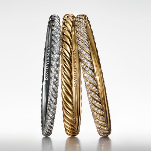 Diamond-encrusted gold and silver sculpted cable bracelets