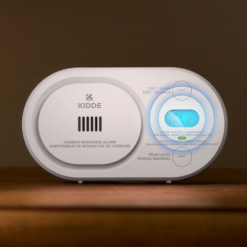A close up of a CO detector showing a lit display.
