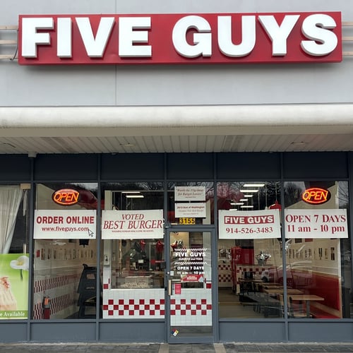 Exterior photograph of the store front of the Five Guys restaurant at 3121 E. Main Street in Mohegan Lake New York.
