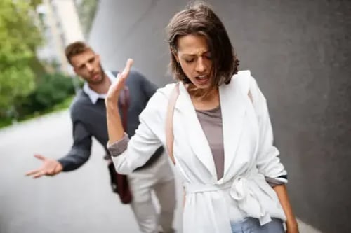 A women leaving an argument with her hands up