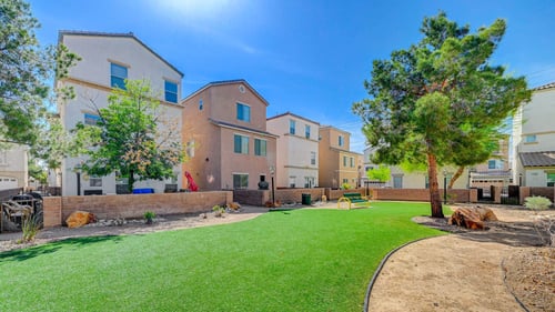 A sunny day at a residential area with a green lawn and a tree at Habitat @ DTLV, Las Vegas, NV, 89106