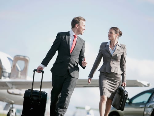 business-couple-travelling-with-bags-at-airport
