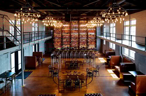 Interior view of The Last Refuge showing the impressive monolithic bottle display wall and bar area.