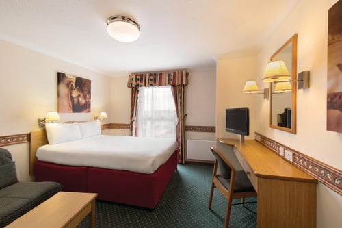 Bedroom with double bed, desk and TV