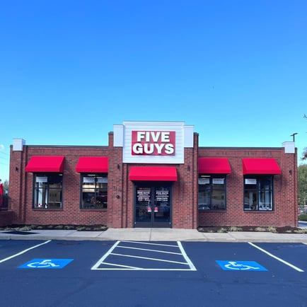 Exterior photograph of the entrance to the Five Guys restaurant at 2570 Lewisville-Clemmons Road in Clemmons North Carolina.