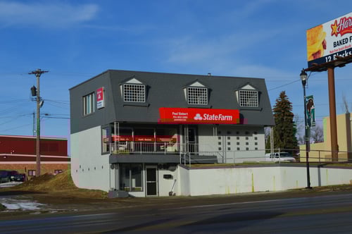 Gray building with red State Farm sign