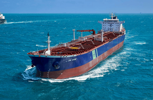 Image of tanker ship passing through shipping channel.