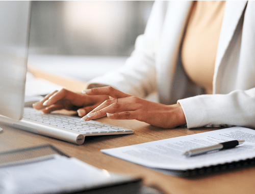 Close up of a business woman typing on a keyboard.