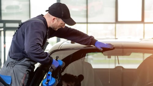 technician installing a new windshield