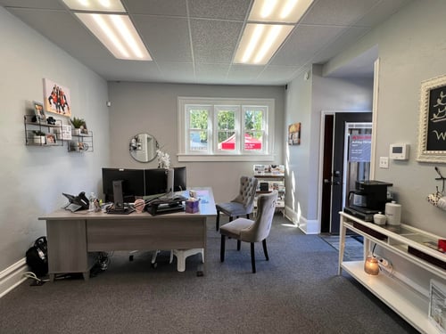 Gray walls with gray desk and gray chairs in office