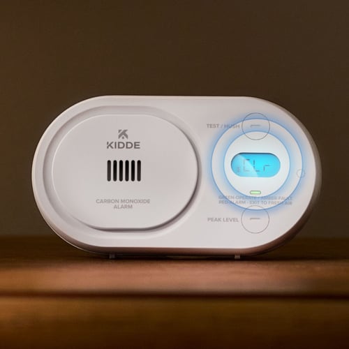 A CO alarm with the display lit and circles highlighting the screen