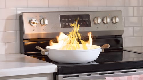 pan on fire on a stovetop