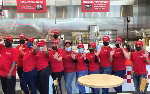 The crew at the Five Guys at 3718 N. Roxboro St., Suite 300, in Durham, North Carolina, pose for a photograph before the store's grand opening.