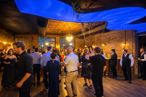 Beautiful royal blue ceiling design with decorative tin ceiling above, with brick walls and wood bar and wood floors with romantic lighting. 140 people gathered together for fun!