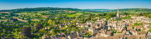 Knight Frank Cirencester Estate Agents - Aerial panorama over idyllic country village cottages green summer fields