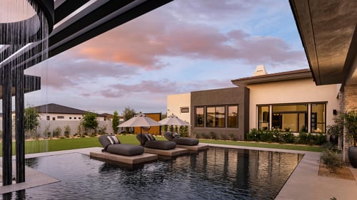 Stunning backyard equipped with pool, expansive back patio for entertaining, and water feature