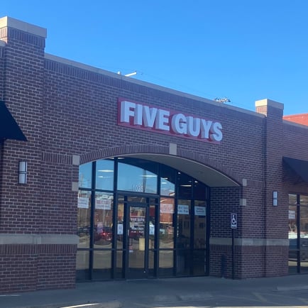 Exterior photograph of the Five Guys restaurant at 1025 East Douglas Avenue in Wichita Kansas.