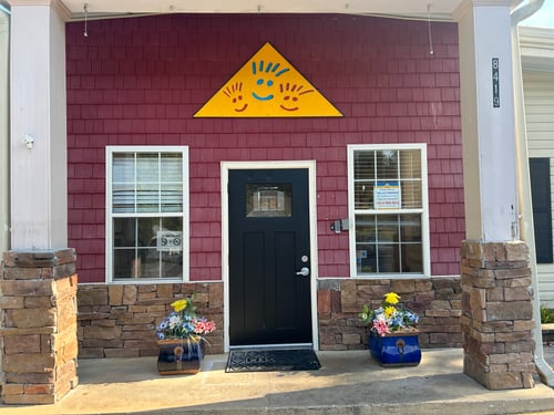 Front view of the school building with a welcoming entrance, designed to create a safe and friendly environment for children and families.