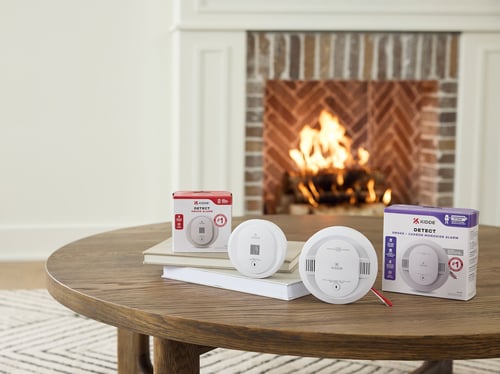 Two DETECT products on the table, next to a fireplace.