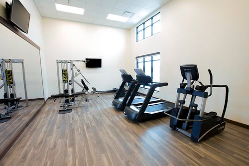 A fitness center in the residential building offers treadmills, elliptical machines and strength training equipment.