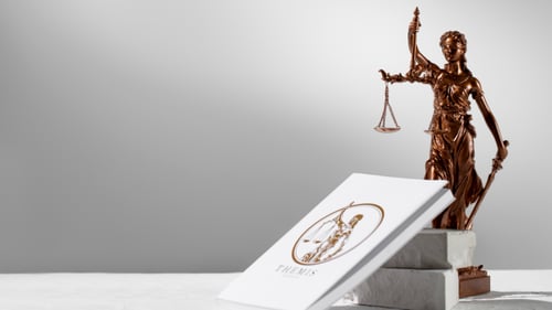 Legal book on table next to a statue