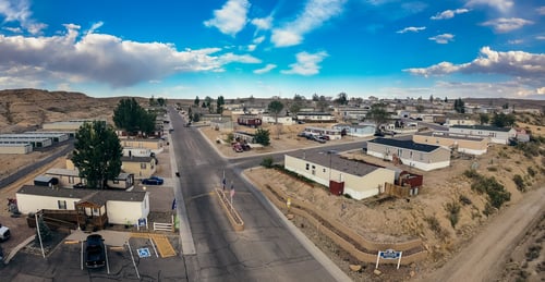 Aerial view of the community showing the roads with a blue sky with some clouds