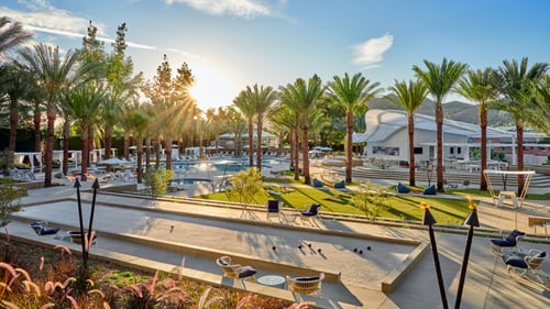 Overlooking a pool and grassy area.