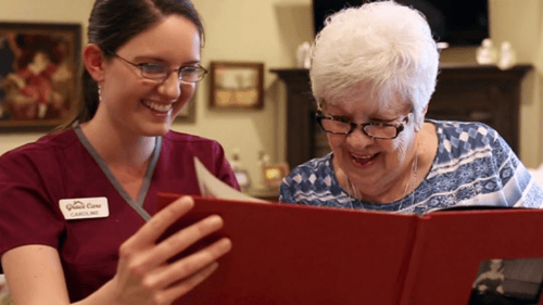 Grace Care - Home Care For Seniors worker and older lady reading
