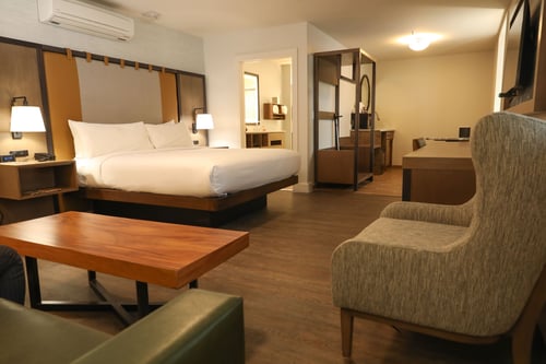 Modern king suite with lounge seating and rustic decor at The Lodge at Breckenridge in scenic Breckenridge, CO.