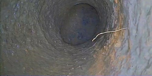 Sewer-camera view of the inside of a pipe during a Bluefrog inspection.