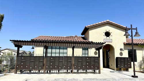 A building with a sign that says at Via Del Lago Homes in Moreno Valley, CA, 92555