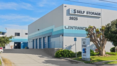 Spencer Street Self Storage facility at 3925 Spencer Street with blue accent stripe, clear entrance signage, and street monument sign