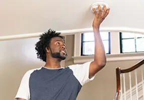 home-safety-man-installing-alarm