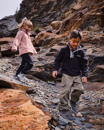 Children hiking on rocks.