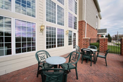Patio located outside of indoor pool area at hotel near Hwy 94