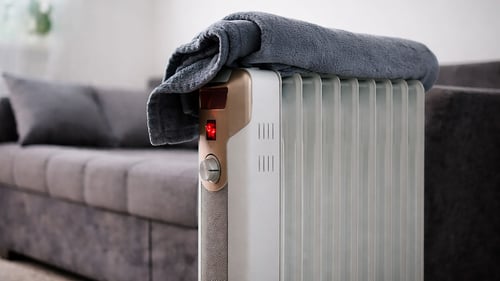 A heater with a towel on it.