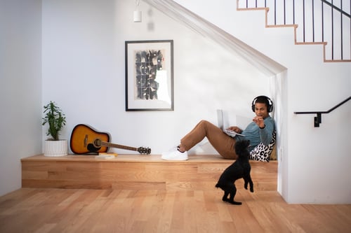 Guy with headphones and dog in nook