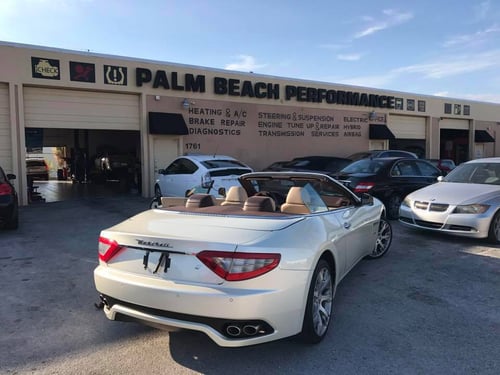 white car in front of shop