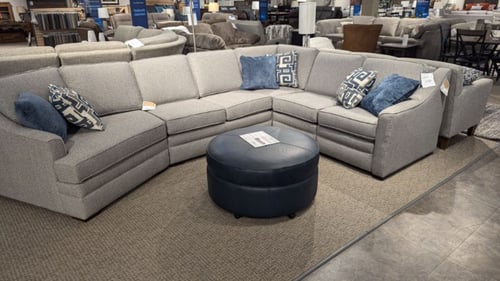 Amery Slumberland Furniture white sectional with matching accent pillows