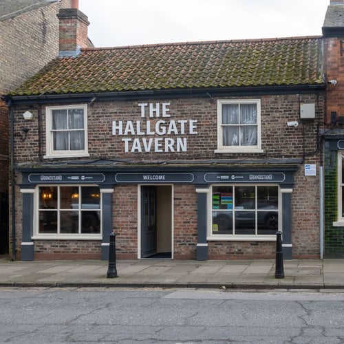 Exterior of The Hallgate Tavern pub with entrance and signage