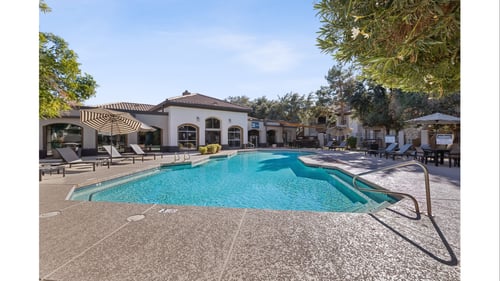 Swimming pool area with clubhouse and lounge chairs at Arcadia Cove Apartments Homes, Phoenix, AZ 85008