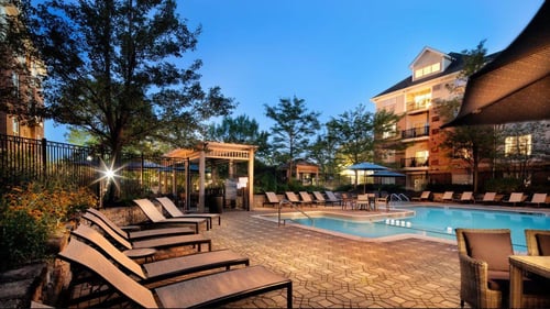 A serene view of the pool at The Aven at Newton Highlands