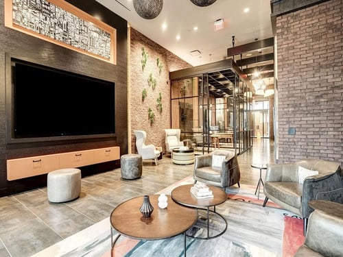 Lobby lounge area with furniture and a large tv at Coda on H in Washington, DC