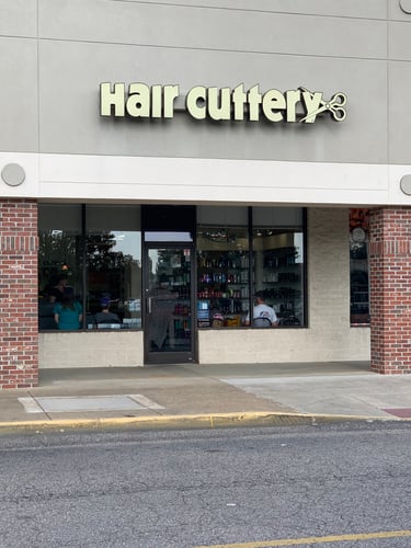 The front entrance of Hair Cuttery at Woodford Square Shopping Center.