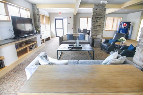 Community clubhouse with sofa, chairs, tables & vending machine, Cedarbrooke Place, Norwalk, IA, 50211