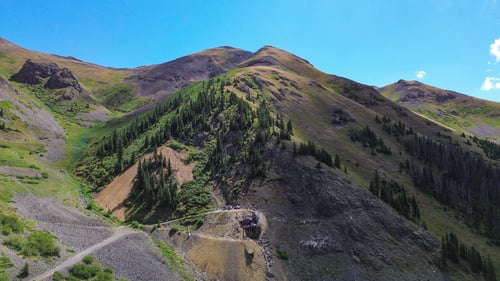 wide shot of a mountain road leading up to an abandoned mine at 12,000 feet in Silverton