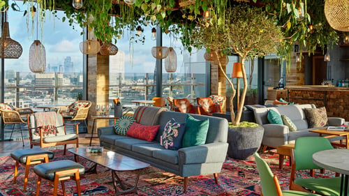 Lounge seating at The Nest rooftop bar inside Treehouse Hotel London.