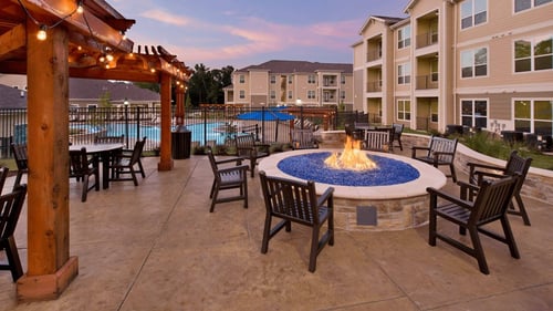 poolside firepit and outdoor lounge at dusk